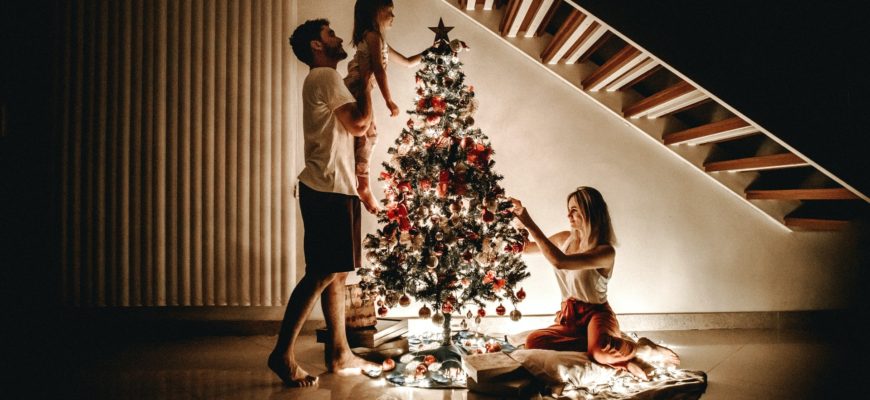 A family decorating the christmas tree