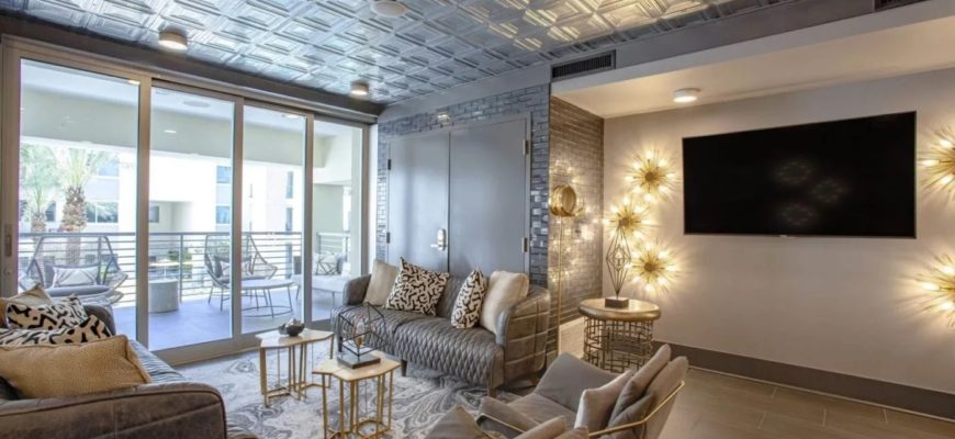 luxury living room with lights behind tv and open sliding doors